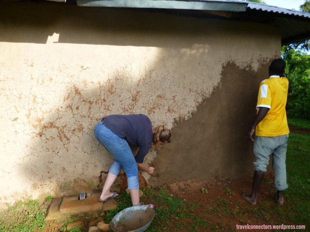 Lena and Paul smearing the wall of our house with a mixture of soil, cow dung and water.